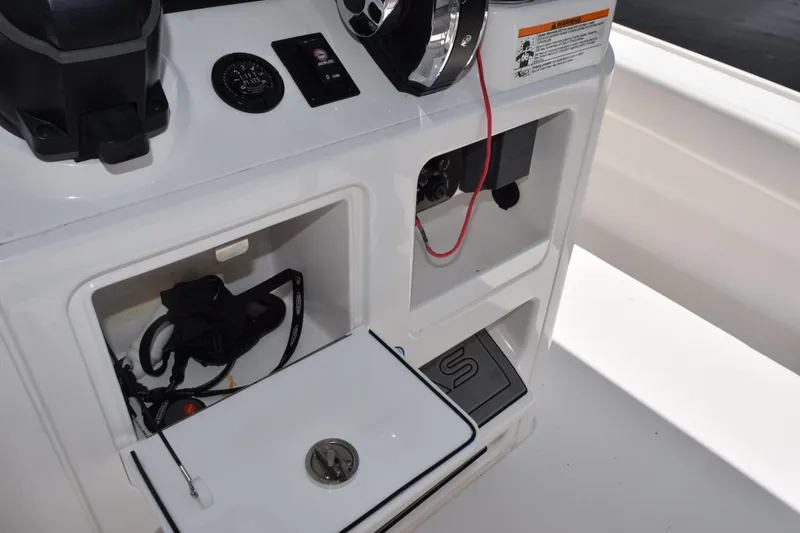 Slide: The Image of 2022 Caymas 26 HB boat console with storage compartments and control panel. - 22