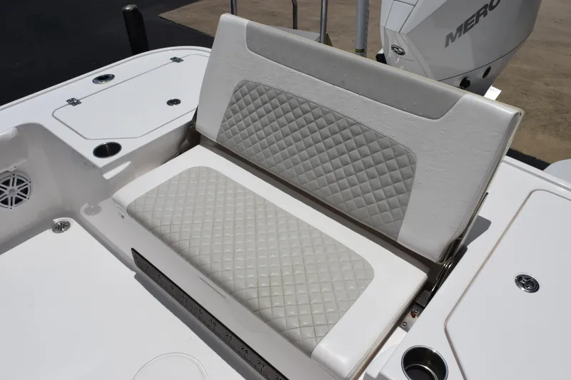 Slide: The Image of 2022 Caymas 26 HB boat seat with diamond-pattern upholstery and storage compartments. - 23