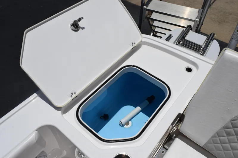 Slide: The Image of 2022 Caymas 26 HB boat with open storage compartment and ladder. - 25