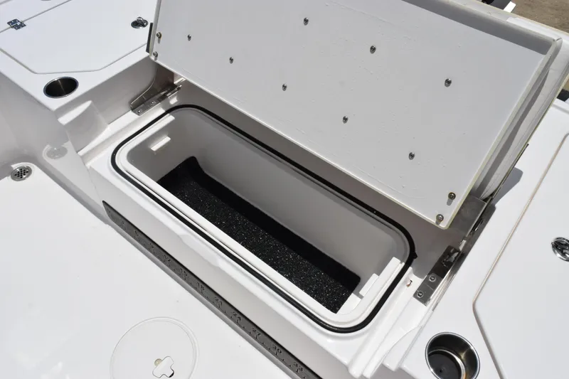 Slide: The Image of Open storage compartment on 2022 Caymas 26 HB boat, showcasing interior space and design. - 26