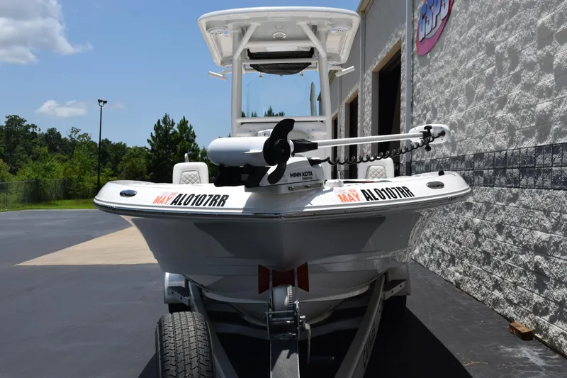 Slide: The Image of 2022 Caymas 26 HB boat on trailer, parked outdoors near a building. - 3