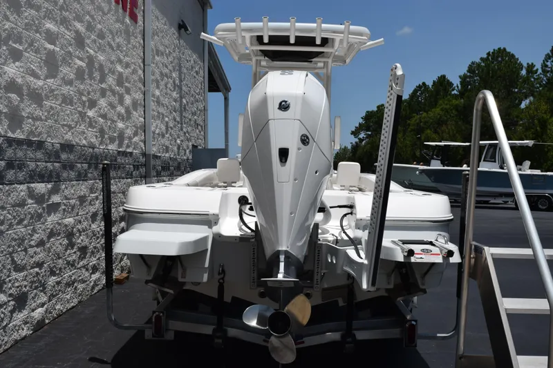 Slide: The Image of 2022 Caymas 26 HB boat, rear view with outboard motor, parked outdoors. - 5