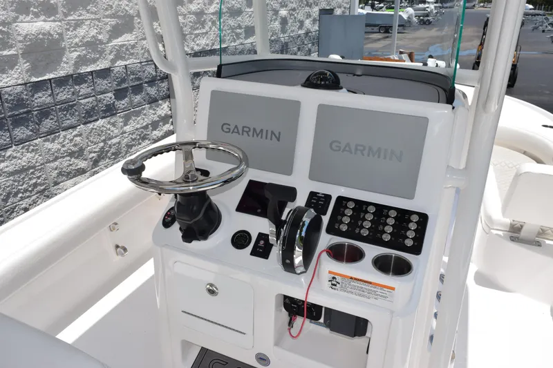 Slide: The Image of 2022 Caymas 26 HB boat console with dual Garmin displays and steering wheel. - 8