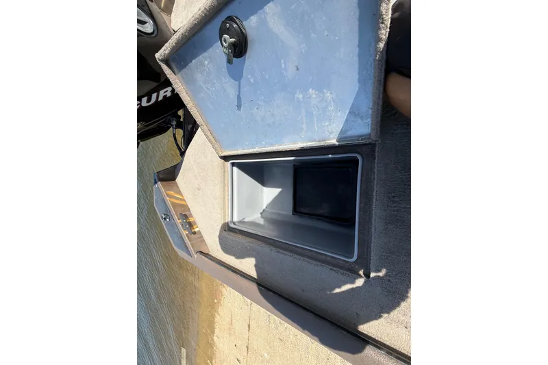 Slide: The Image of Open storage compartment on a 2010 SeaArk Stealth 190 boat, near water. - 29