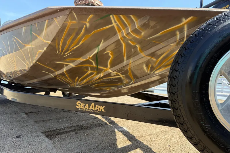 Slide: The Image of 2010 SeaArk Stealth 190 boat with camouflage design on a trailer. - 17