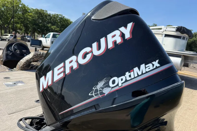 Slide: The Image of Mercury OptiMax engine on 2010 SeaArk Stealth 190 boat, parked outdoors. - 10