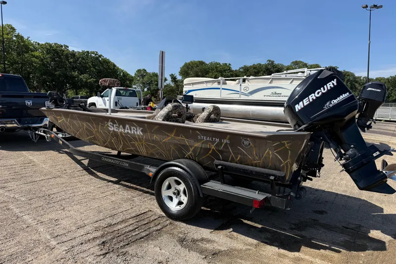 Slide: The Image of 2010 SeaArk Stealth 190 boat with Mercury engine on trailer in parking lot. - 7