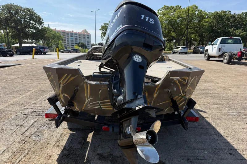 Slide: The Image of 2010 SeaArk Stealth 190 boat with Mercury outboard motor on a trailer in a parking lot. - 1