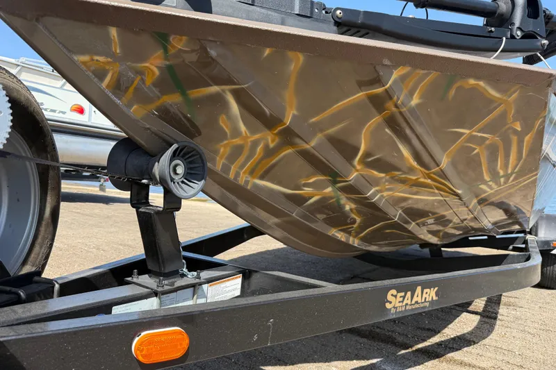 Slide: The Image of 2010 SeaArk Stealth 190 boat hull on trailer, showcasing camouflage design. - 18