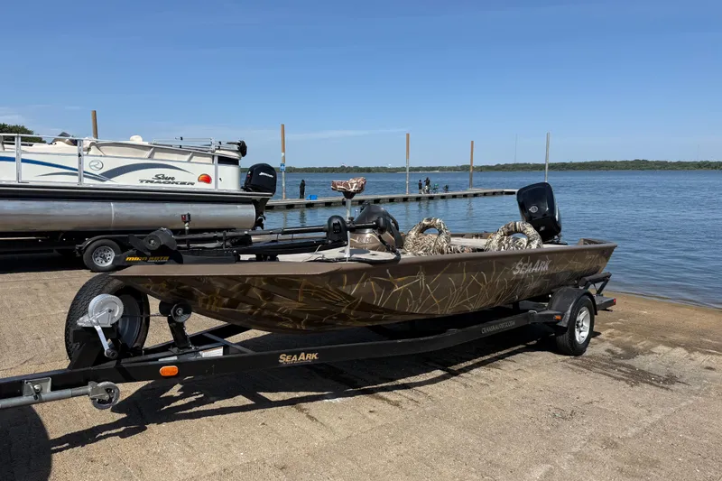 Slide: The Image of 2010 SeaArk Stealth 190 boat on trailer by lake, ready for launch. - 1