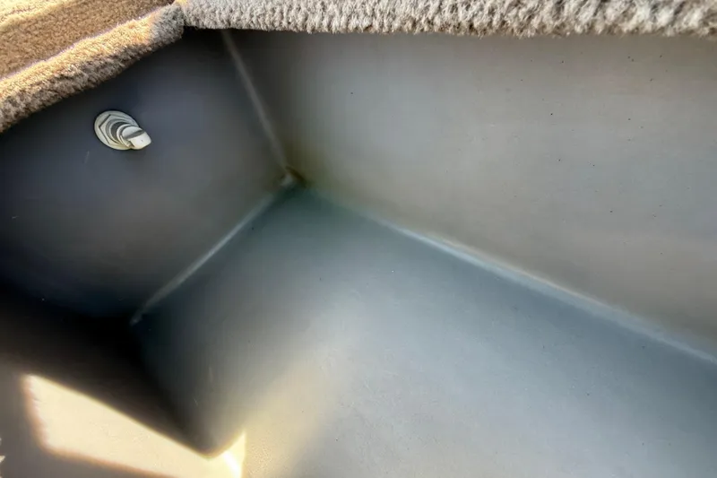 Slide: The Image of Interior view of a 2010 SeaArk Stealth 190 boat compartment with carpeted edge. - 32