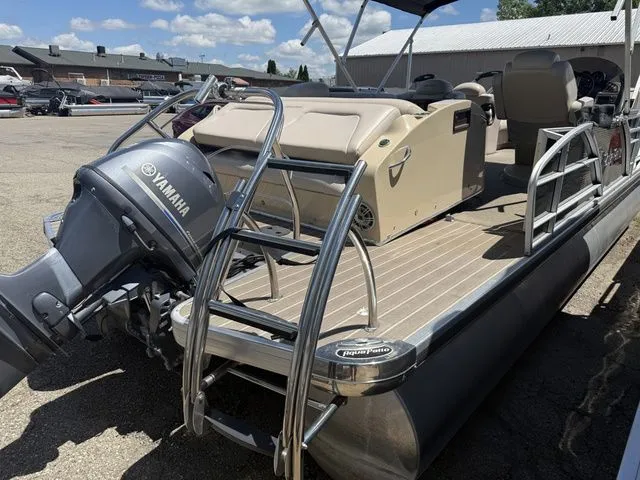 Slide: The Image of A 2014 Godfrey AP 240 pontoon boat with a Yamaha outboard motor, parked in a lot. - 10