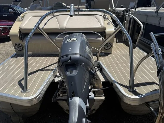 Slide: The Image of The image shows the rear of a Godfrey AP 240 pontoon boat with an outboard motor. - 11