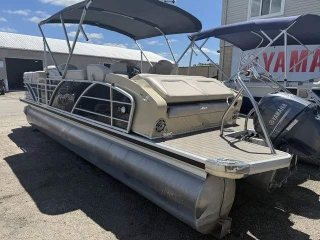 Slide: The Image of A 2014 Godfrey AP 240 pontoon boat with a canopy, parked on a lot. - 3