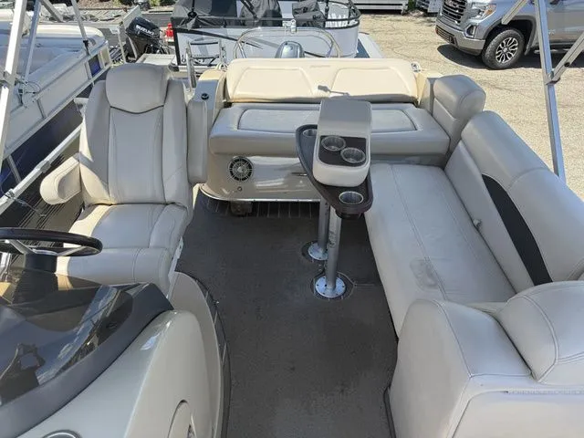 Slide: The Image of Interior of a 2014 Godfrey AP 240 boat with beige seating and a table. - 5