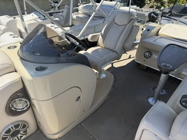 Slide: The Image of Interior of a 2014 Godfrey AP 240 with beige leather seats and a modern helm station. - 8
