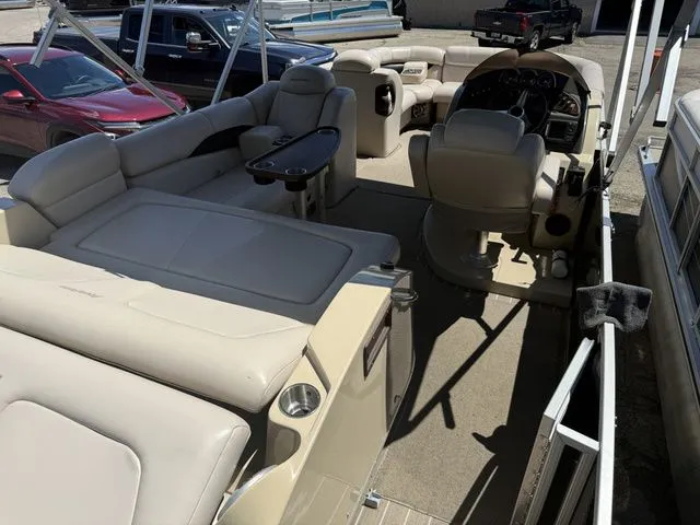 Slide: The Image of Interior of a Godfrey AP 240 pontoon boat with beige seating and helm station. - 9