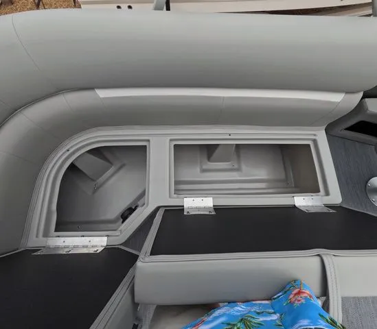 Slide: The Image of Interior view of a boat with gray upholstery and storage compartments under the seats. - 10