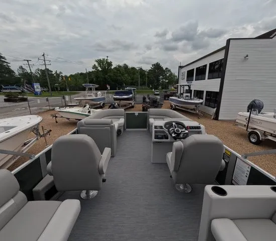 Slide: The Image of The image shows the interior of a pontoon boat with gray seating and a helm station. - 11