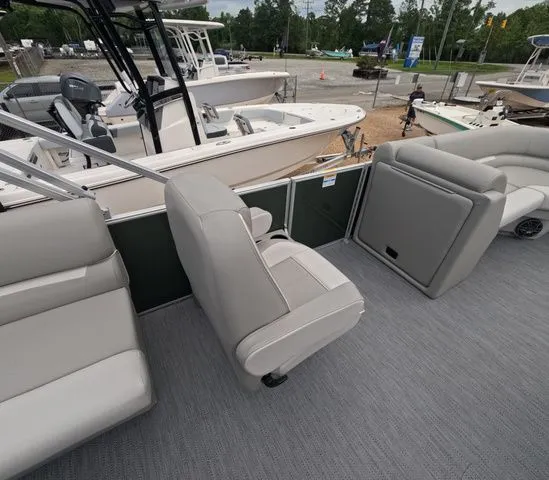 Slide: The Image of Interior view of a modern pontoon boat with gray seating and carpeted flooring. - 14