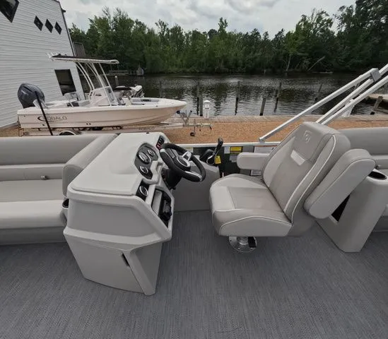 Slide: The Image of The image shows the cockpit of a 2027 Godfrey Xperience Lounge 2286 SBX with gray seats and a helm. - 15