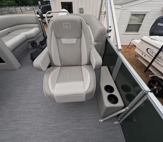 Slide: The Image of A luxurious seat on a modern pontoon boat with gray upholstery and cup holders. - 18