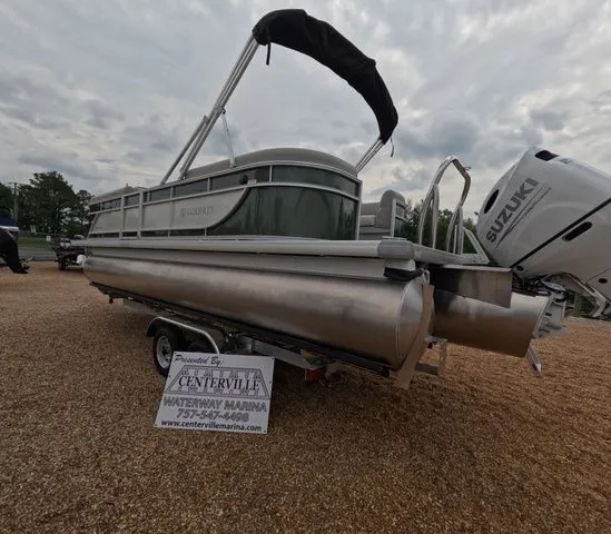 Slide: The Image of A Godfrey Xperience Lounge 2286 SBX pontoon boat on a trailer, featuring a Suzuki outboard motor. - 2
