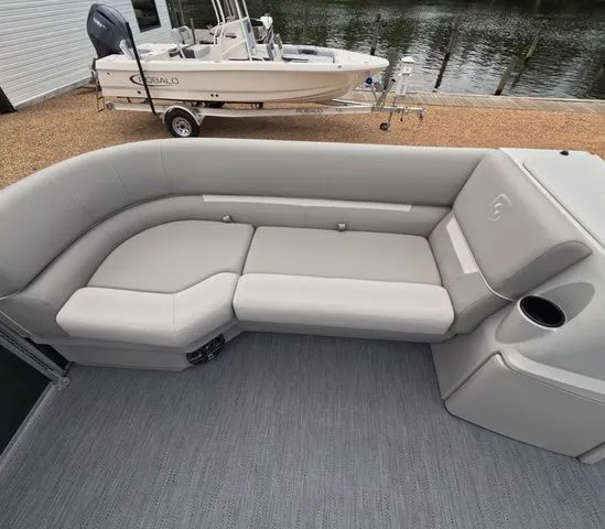 Slide: The Image of The image shows a gray seating area on a boat, with a cup holder beside it. - 20