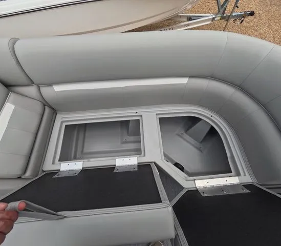 Slide: The Image of Interior view of a boat with gray upholstered seats and open storage compartments. - 23
