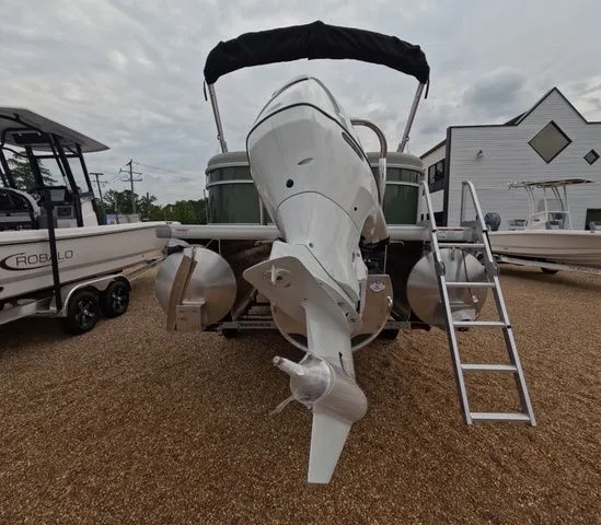 Slide: The Image of The image shows a 2027 Godfrey Xperience Lounge 2286 SBX boat with an outboard motor. - 3