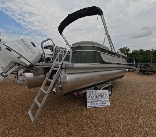 Slide: The Image of A Godfrey Xperience Lounge 2286 SBX pontoon boat on a trailer, with Suzuki engine and ladder. - 4