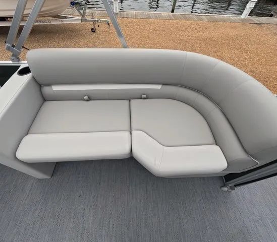 Slide: The Image of The image shows a gray upholstered seating area on a boat docked by the water. - 8