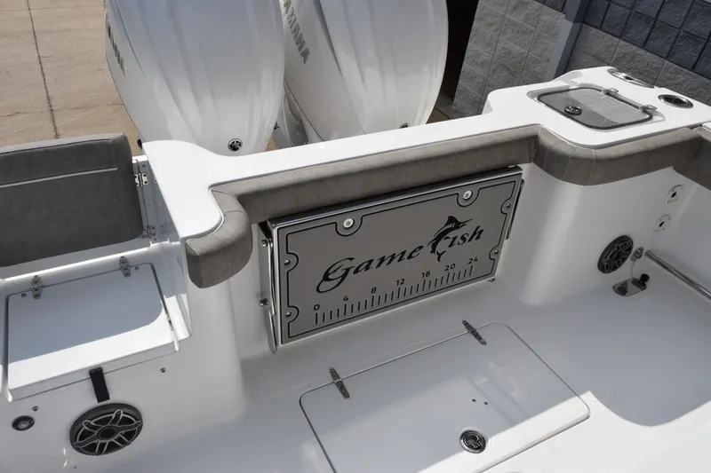 Slide: The Image of 2026 Sea Hunt Gamefish 28 Coffin Box boat interior with dual engines and storage compartments. - 8
