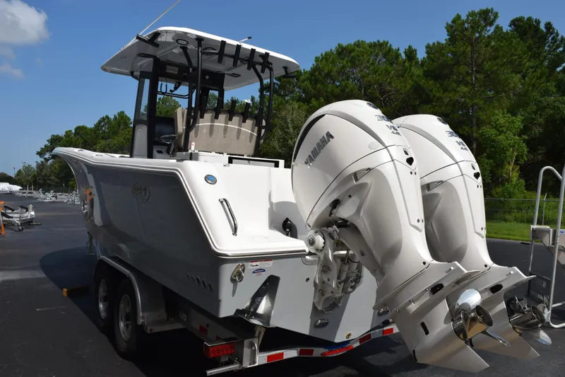 Slide: The Image of 2026 Sea Hunt Gamefish 28 Coffin Box boat with dual Yamaha engines on a trailer. - 6