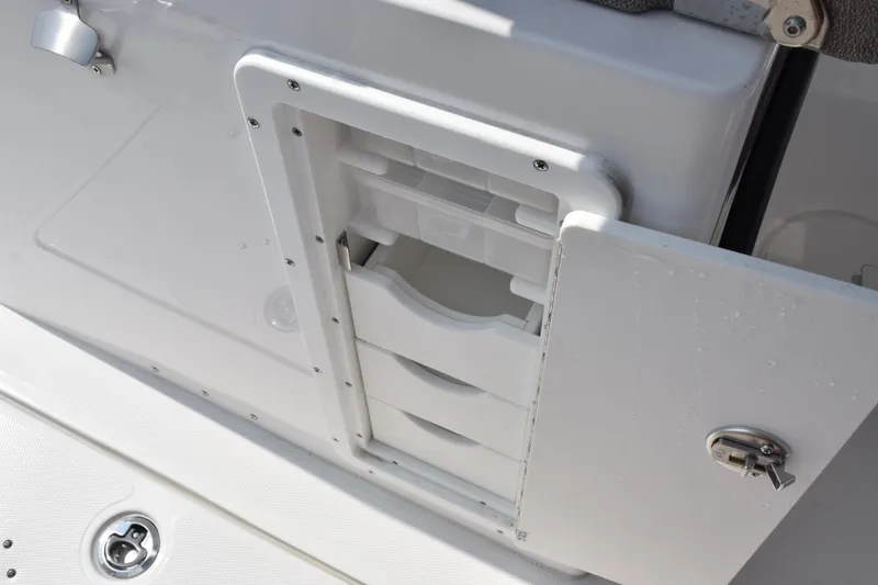 Slide: The Image of Storage compartment on 2026 Sea Hunt Gamefish 28 Coffin Box boat, featuring secure latch. - 16