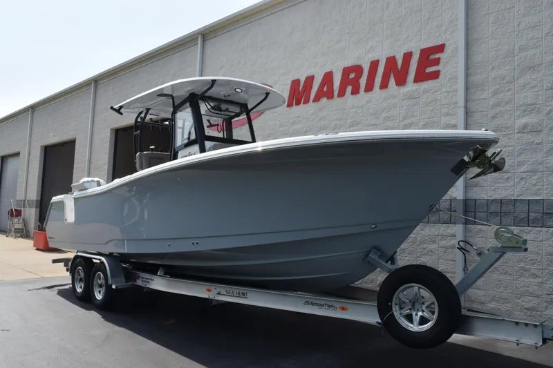 Slide: The Image of 2026 Sea Hunt Gamefish 28 Coffin Box boat on trailer outside marine facility. - 2