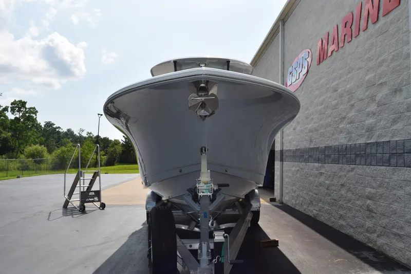 Slide: The Image of 2026 Sea Hunt Gamefish 28 Coffin Box boat on trailer outside marine store. - 3