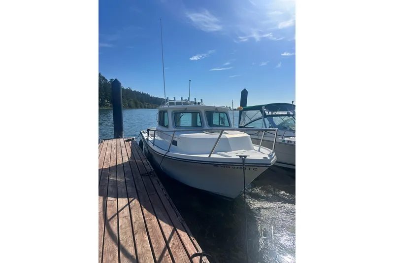 The Image of 2022 Parker 2120 Sport Cabin boat docked on a sunny day. - 0