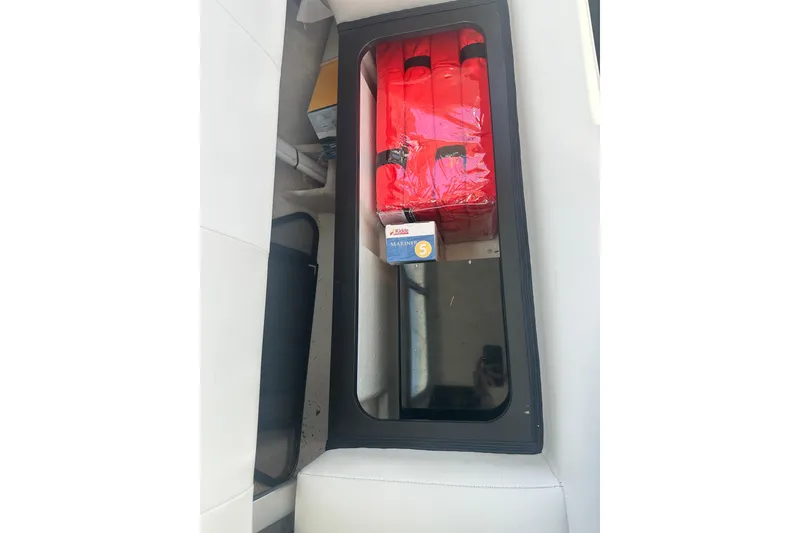Slide: The Image of Storage compartment in 2022 Parker 2120 Sport Cabin with safety gear and supplies. - 20