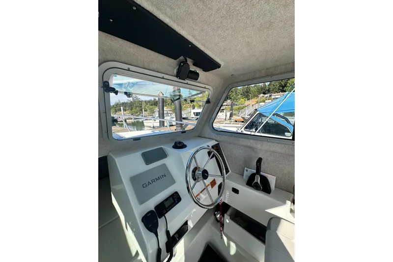 Slide: The Image of Interior view of 2022 Parker 2120 Sport Cabin boat with Garmin navigation system. - 25