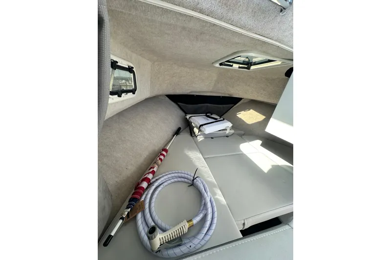 Slide: The Image of Interior of 2022 Parker 2120 Sport Cabin with seating and boating equipment. - 26