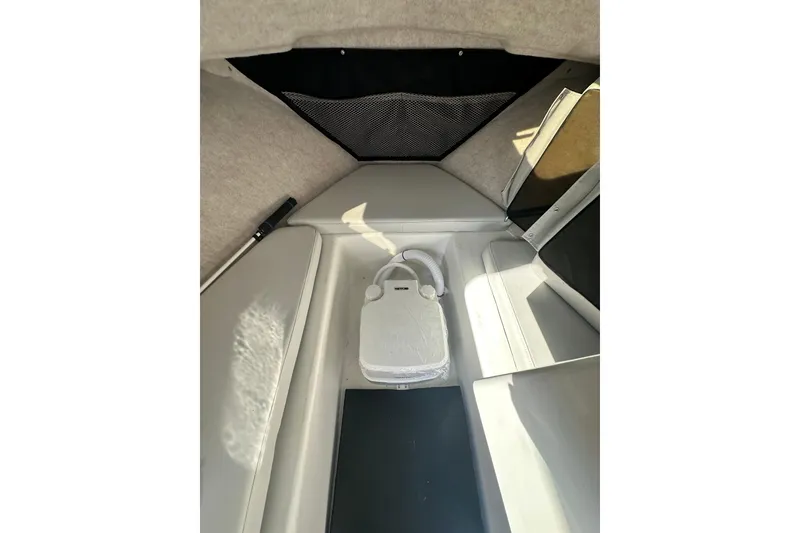 Slide: The Image of Interior cabin of 2022 Parker 2120 Sport Cabin boat, featuring compact seating and storage. - 27