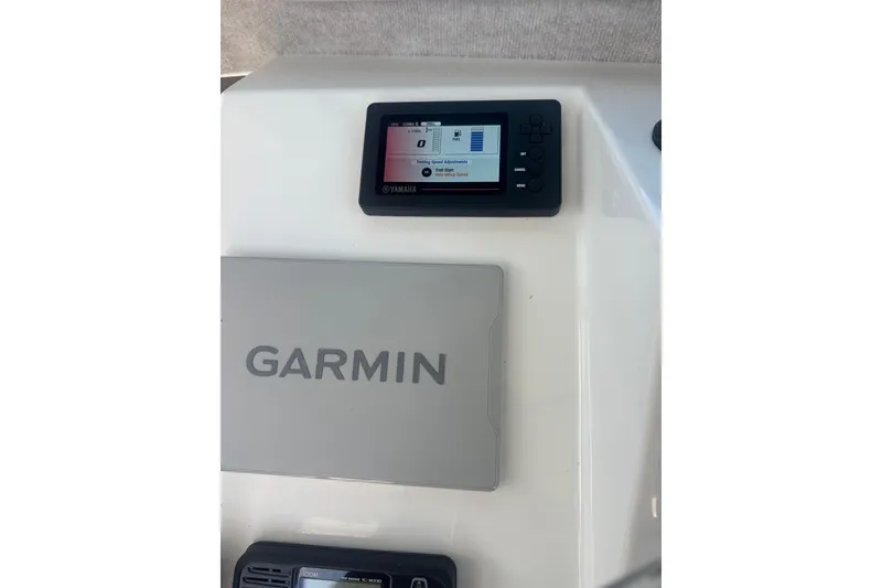 Slide: The Image of Garmin and Yamaha displays on 2022 Parker 2120 Sport Cabin boat dashboard. - 29