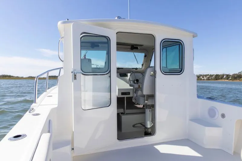 Slide: The Image of Manufacturer Provided Image: 2022 Parker 2120 Sport Cabin boat interior view on water. - 38