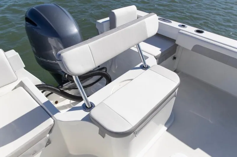 Slide: The Image of Manufacturer Provided Image: Parker 2120 Sport Cabin 2022 boat interior with cushioned seating and outboard motor. - 41