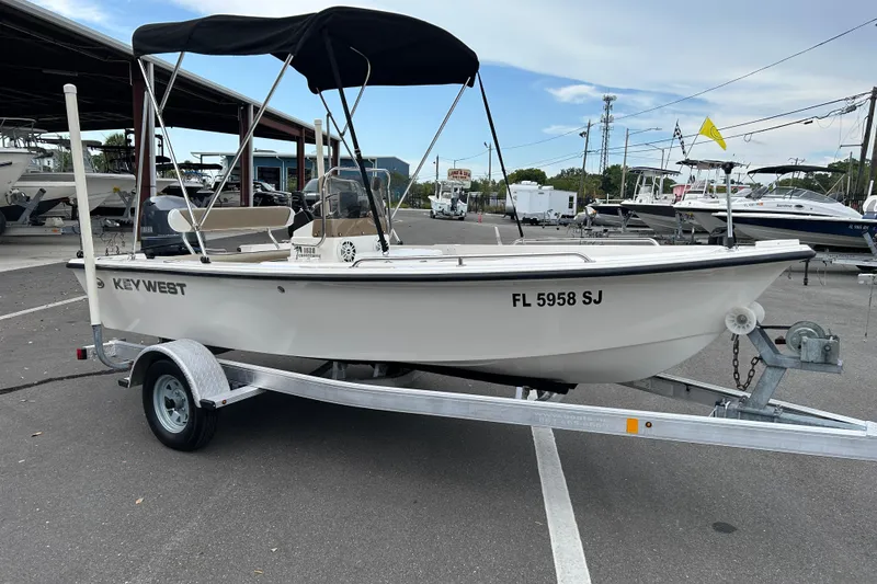 The Image of 2016 Key West 1520 Center Console boat on trailer in marina parking lot. - 1
