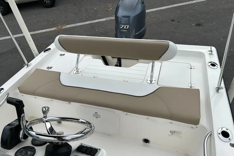 Slide: The Image of 2016 Key West 1520 Center Console boat interior with steering wheel and Yamaha 70 engine. - 10
