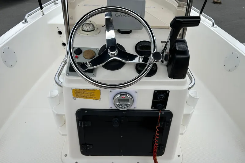 Slide: The Image of 2016 Key West 1520 Center Console boat dashboard with steering wheel and controls. - 11