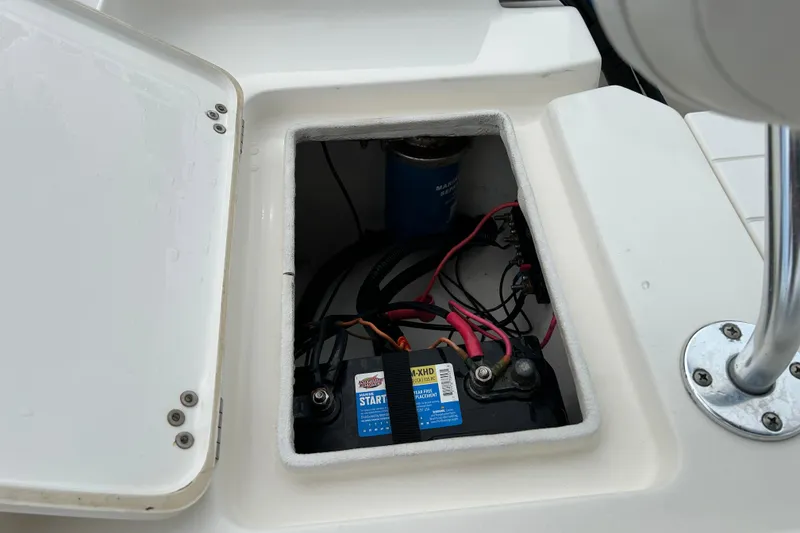 Slide: The Image of Battery compartment of 2016 Key West 1520 Center Console boat, showing wiring and connections. - 15