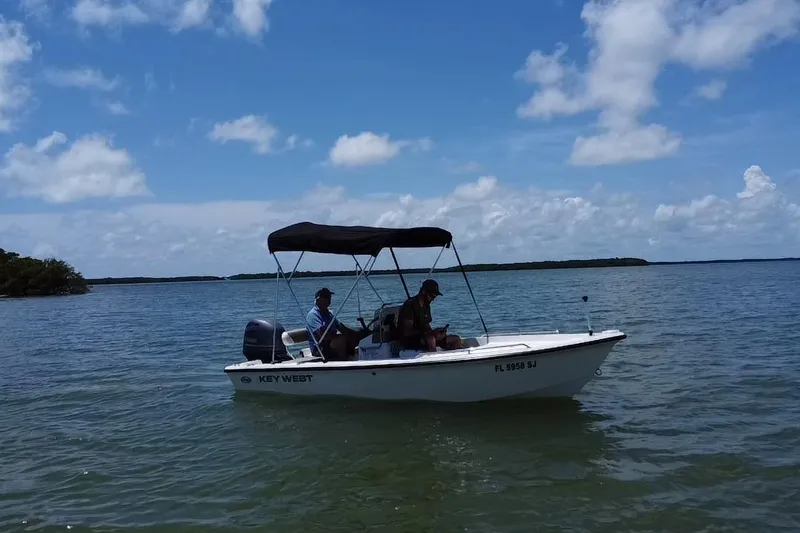 Slide: The Image of 2016 Key West 1520 Center Console boat on calm waters under a clear blue sky. - 18